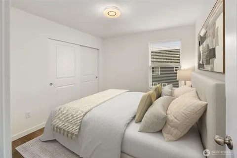 a bedroom with bed and a window