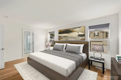 a bedroom with a large bed and a painting on the wall