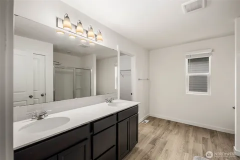 a bathroom with a double vanity sink and mirror
