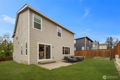 a backyard of a house with table and chairs