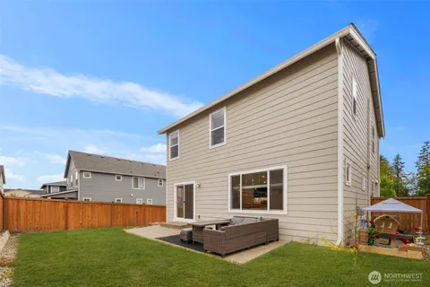 a backyard of a house with table and chairs