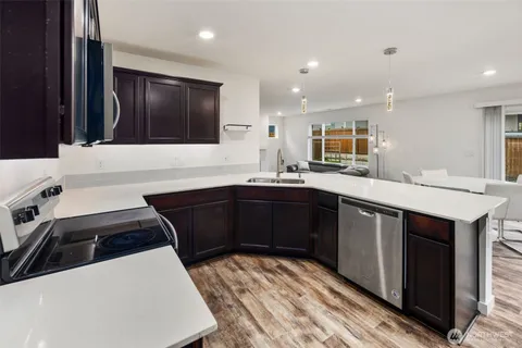 a kitchen with a sink and a stove top oven