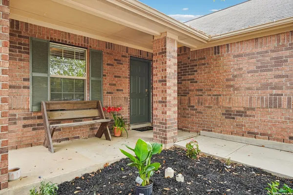 a view of front door of house with outdoor seating