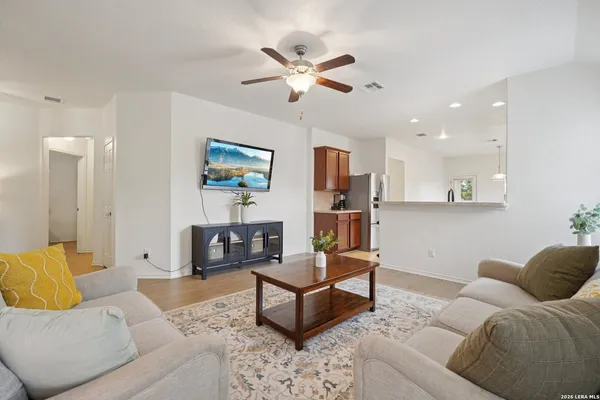 a living room with furniture and a ceiling fan