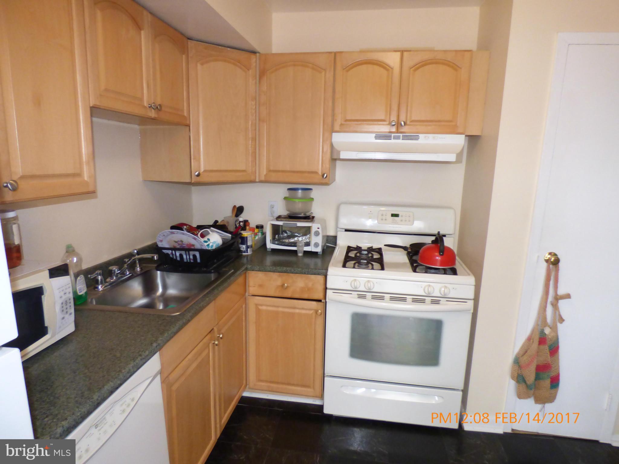 3940 Bel Pre Road, Unit 7 Silver Spring, MD 20906 - Photo 2 of 17 a kitchen with white cabinets and white appliances