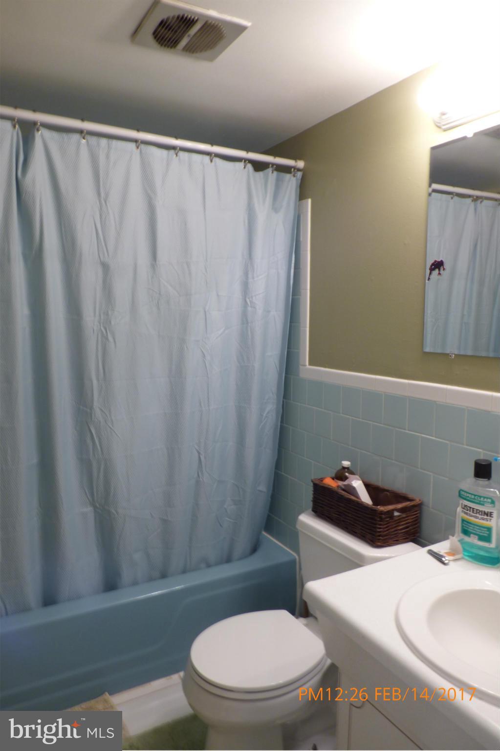 3940 Bel Pre Road, Unit 7 Silver Spring, MD 20906 - Photo 13 of 17 a white toilet sitting next to a bath tub