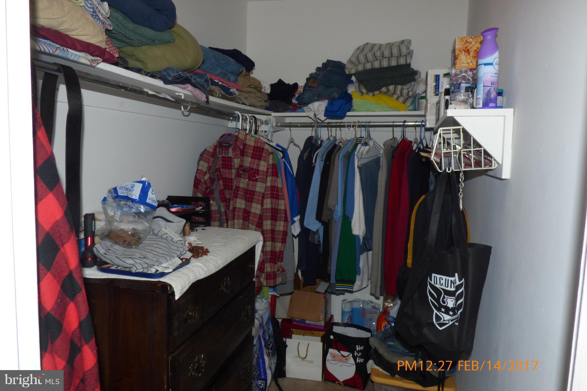 3940 Bel Pre Road, Unit 7 Silver Spring, MD 20906 - Photo 14 of 17 a view of walk in closet with clothes and shoes