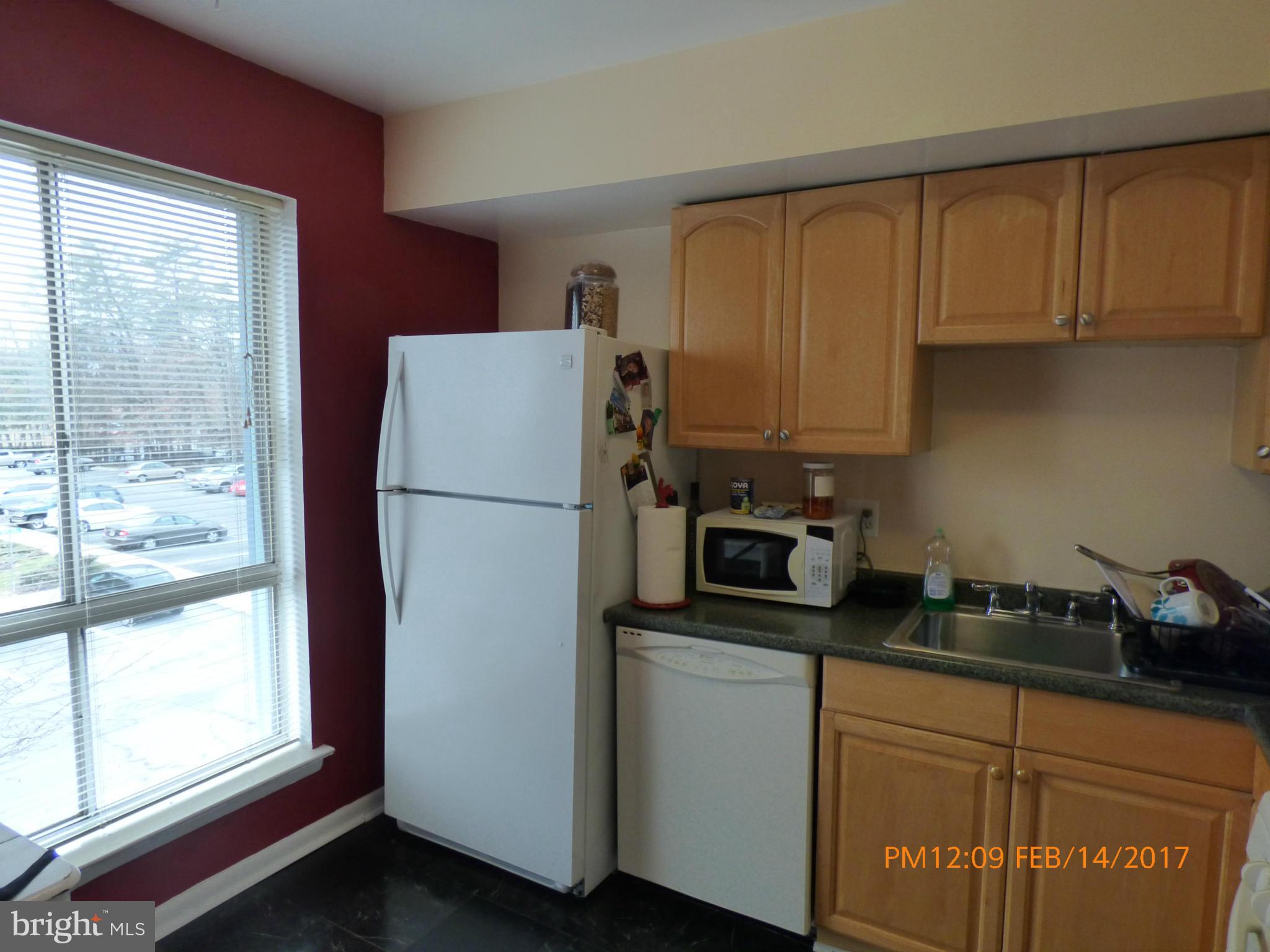 3940 Bel Pre Road, Unit 7 Silver Spring, MD 20906 - Photo 3 of 17 a kitchen with a refrigerator and a stove