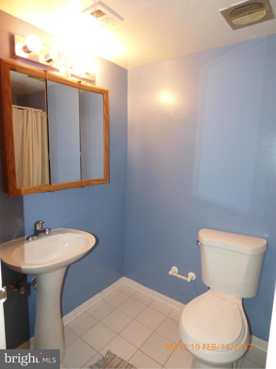 3940 Bel Pre Road, Unit 7 Silver Spring, MD 20906 - Photo 8 of 17 a white toilet sitting next to a bathroom sink