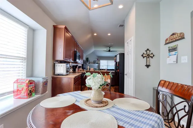 a dining room with furniture and wooden floor
