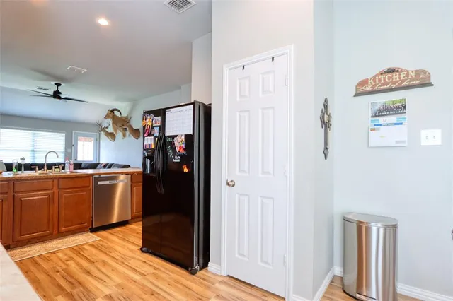 a kitchen with stainless steel appliances granite countertop a refrigerator and a sink