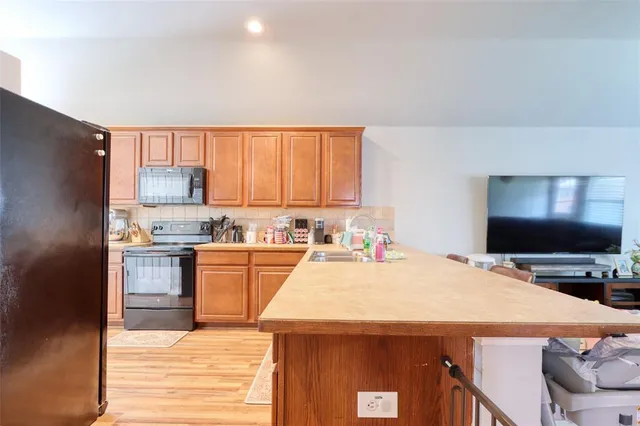 a kitchen with a stove a sink and a refrigerator