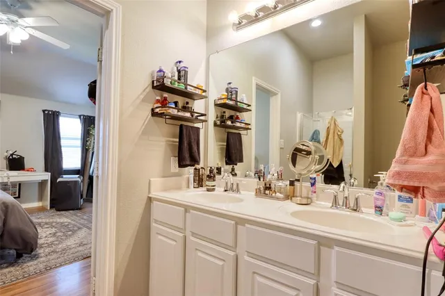 a en suite bathroom with a double vanity sink and a mirror