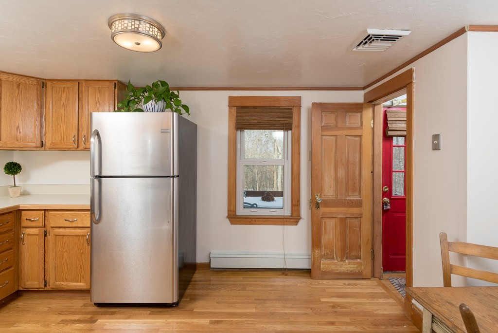88 Manatee Road Hingham, MA 02043 - Photo 8 of 21 a refrigerator freezer sitting in a kitchen with stainless steel appliances granite countertop cabinets and wooden floor