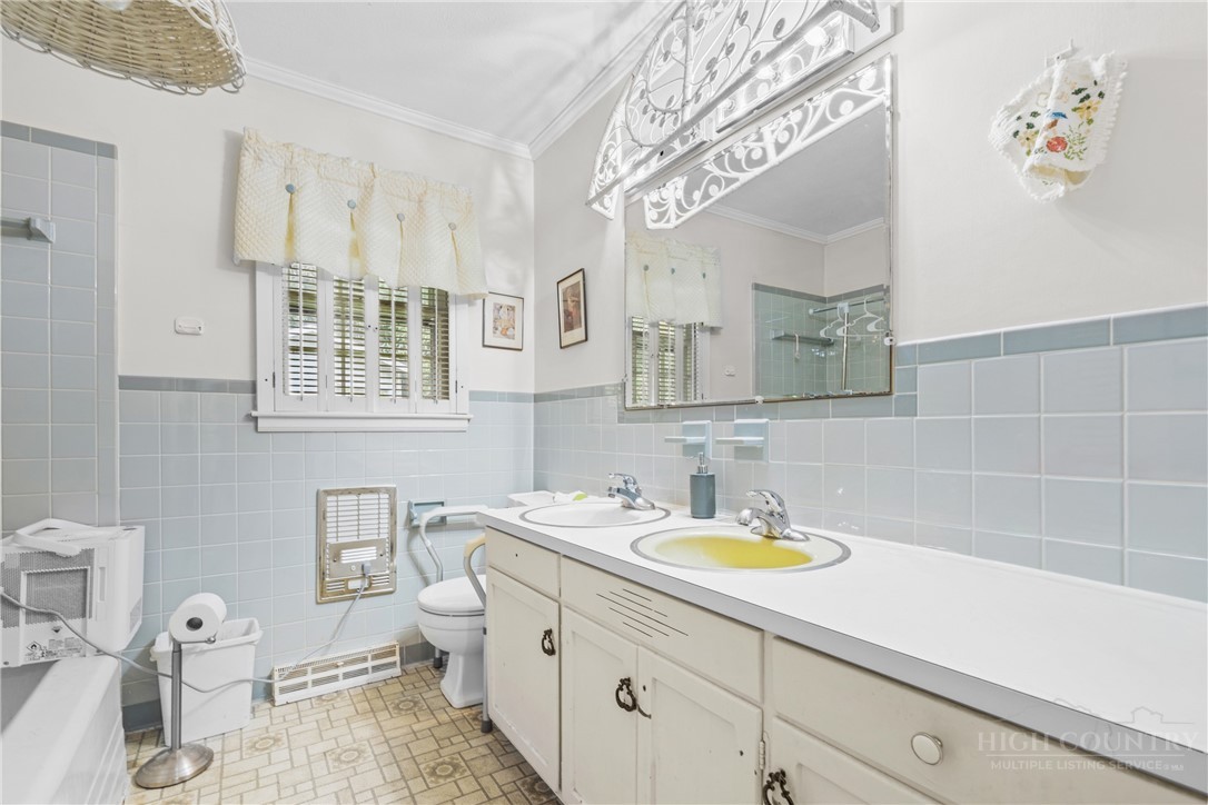 1794 Highway 105 Boone, NC 28607 - Photo 29 of 29 a bathroom with a sink a toilet and a mirror