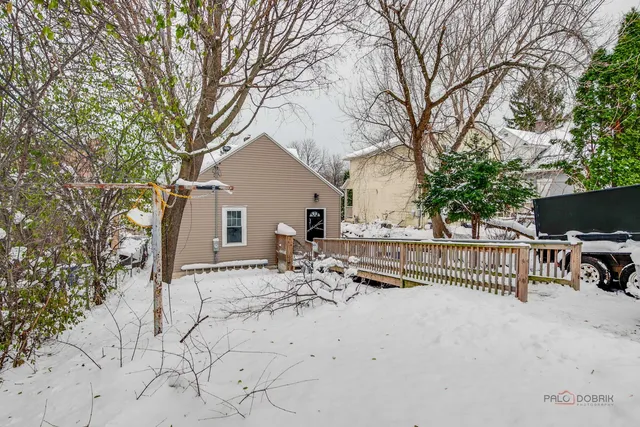 a view of house with backyard and trees