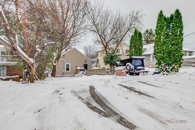 a view of a house with snow on the road