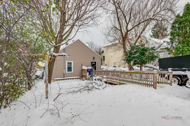 a view of house with backyard and sitting area