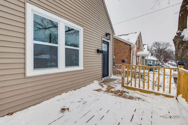 a view of a house with a wooden fence