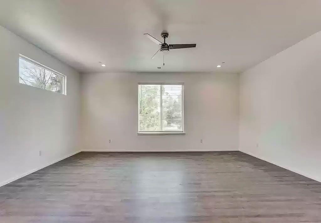 3275 Dallas Street, Unit 307 Dallas, TX 75210 - Photo 5 of 10 an empty room with wooden floor and windows