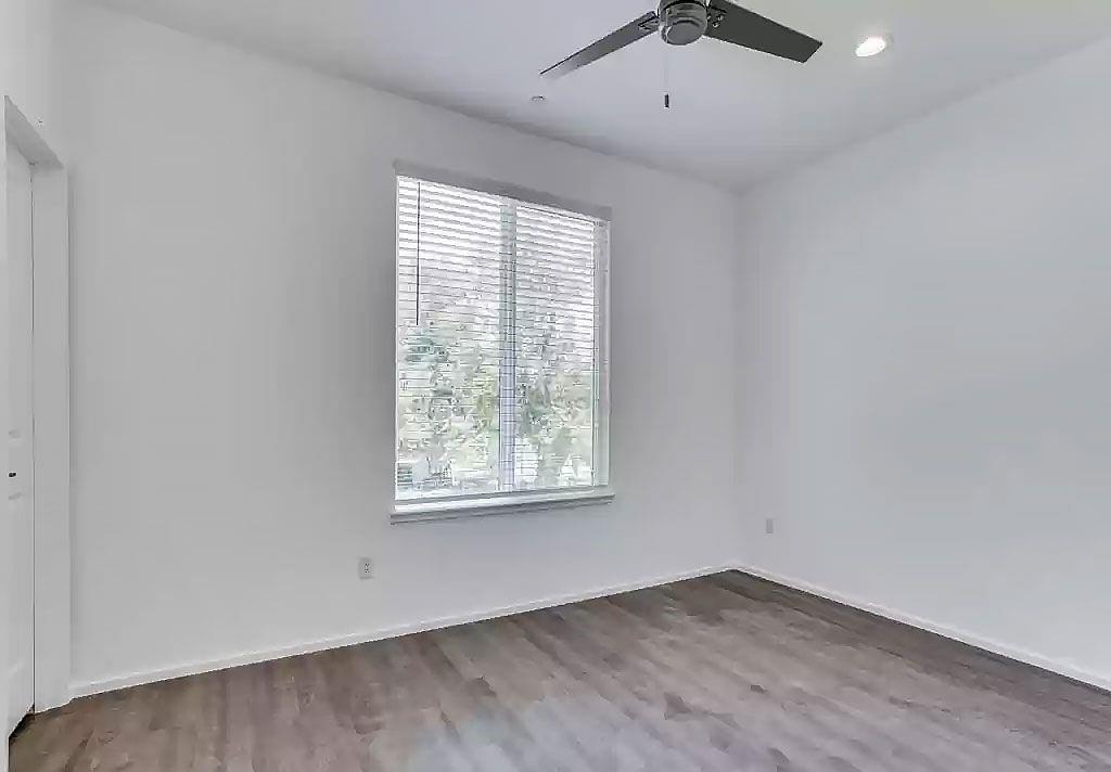 3275 Dallas Street, Unit 307 Dallas, TX 75210 - Photo 7 of 10 an empty room with wooden floor and windows
