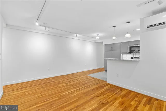 a view of a kitchen with a dishwasher and a white cabinets