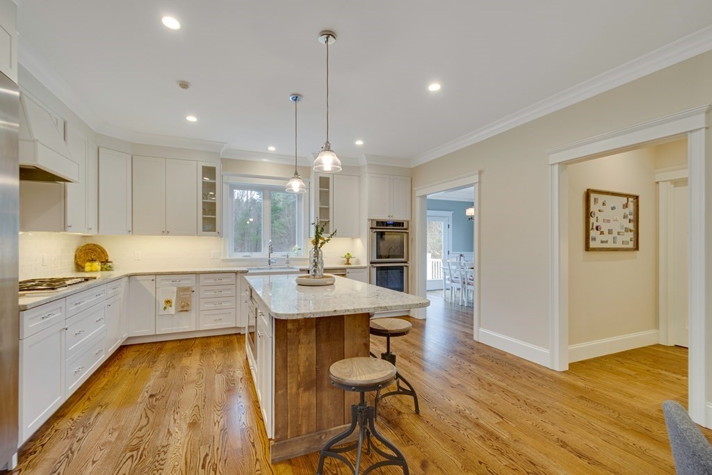 324 Concord Road Bedford, MA 01730 - Photo 13 of 42 a kitchen with counter space dining table and chairs