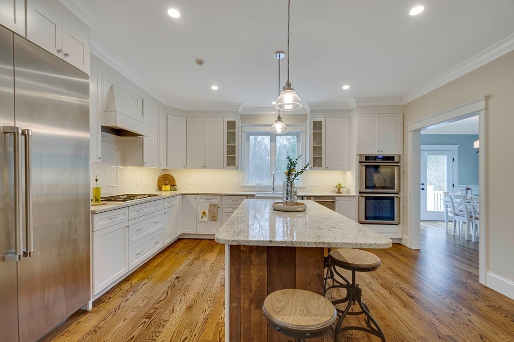 324 Concord Road Bedford, MA 01730 - Photo 19 of 42 a kitchen with sink cabinets and wooden floor