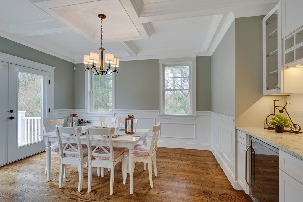 324 Concord Road Bedford, MA 01730 - Photo 20 of 42 a dining room with furniture a chandelier and wooden floor