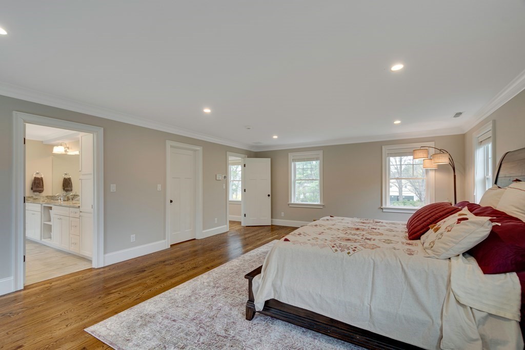 324 Concord Road Bedford, MA 01730 - Photo 26 of 42 a bedroom with a bed and a large mirror
