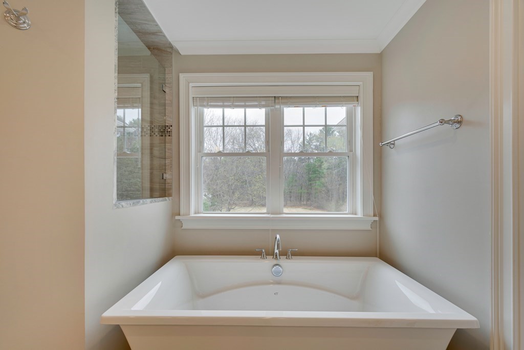324 Concord Road Bedford, MA 01730 - Photo 28 of 42 a white bath tub sitting in a bathroom next to a window
