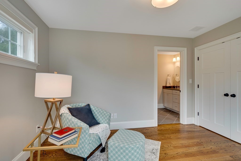 324 Concord Road Bedford, MA 01730 - Photo 31 of 42 a bedroom with a bed and a lamp