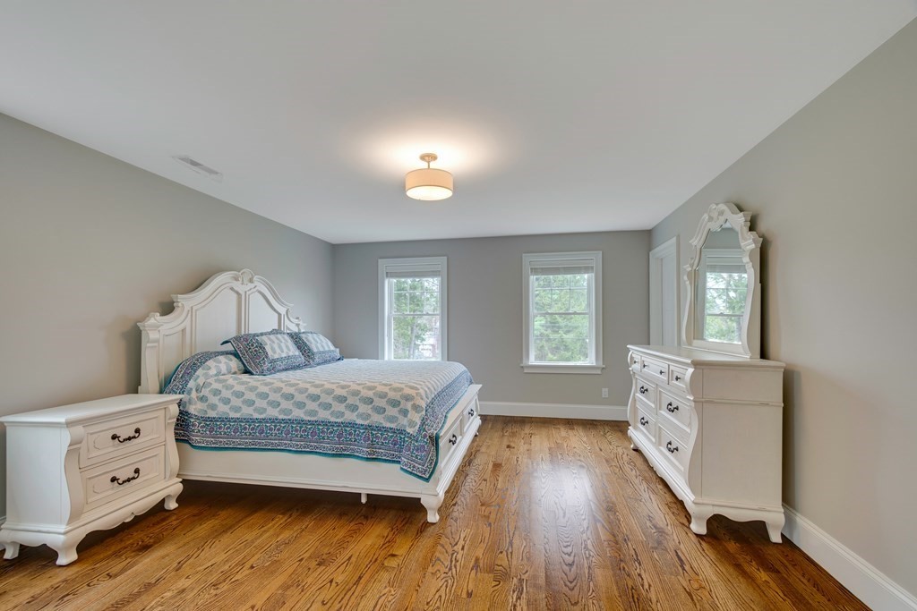 324 Concord Road Bedford, MA 01730 - Photo 33 of 42 a bedroom with a bed and a dresser