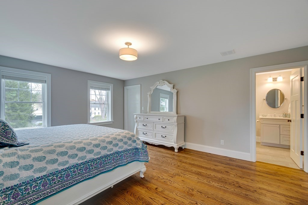 324 Concord Road Bedford, MA 01730 - Photo 34 of 42 a bedroom with a bed and wooden floor
