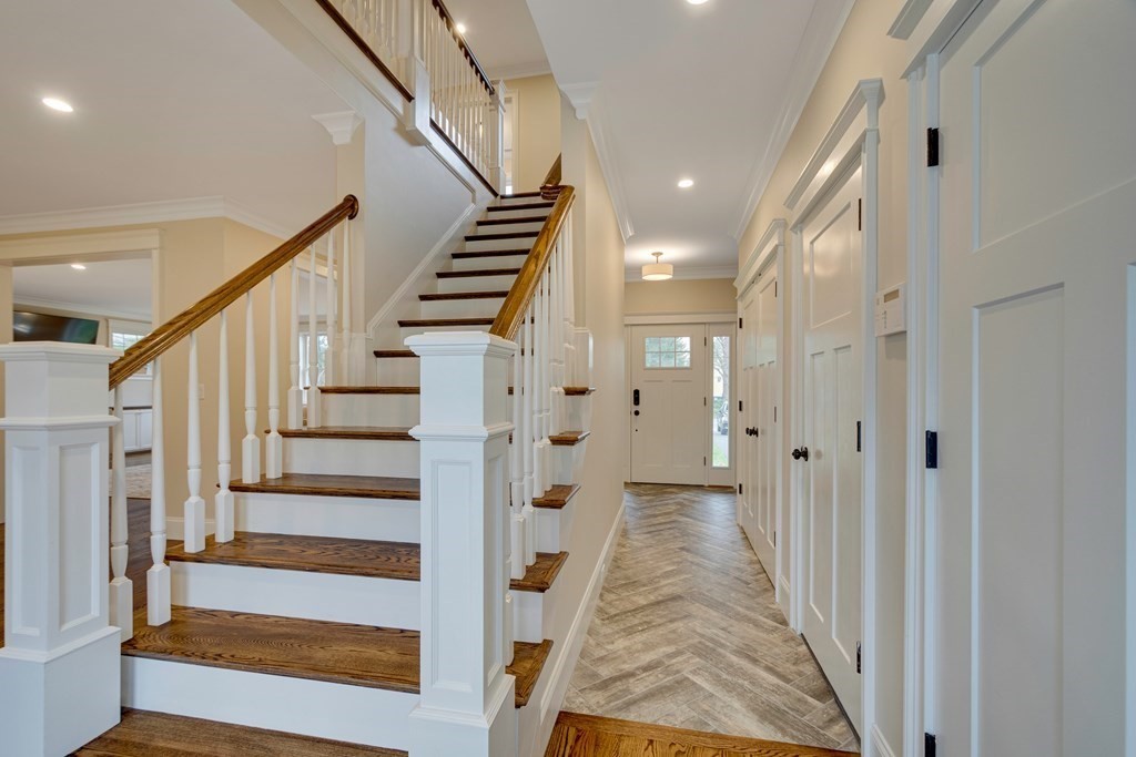 324 Concord Road Bedford, MA 01730 - Photo 4 of 42 a view of a hallway with wooden floor and stairs