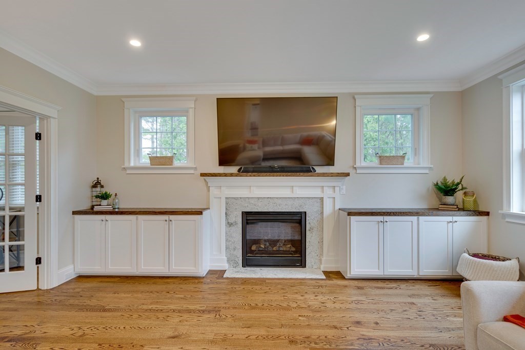 324 Concord Road Bedford, MA 01730 - Photo 8 of 42 a living room with furniture a fireplace and a flat screen tv