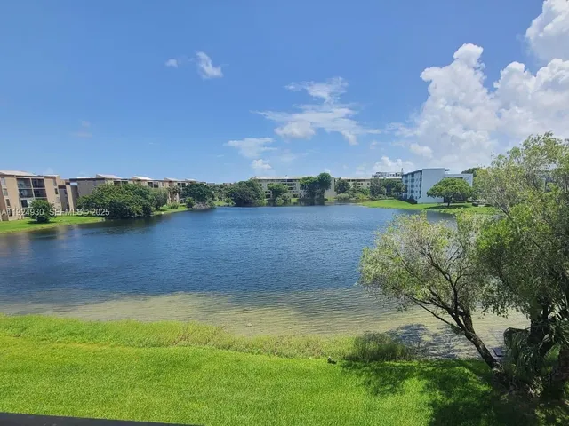 a view of a lake with houses in the background