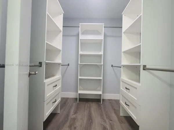 a room with walk in closet and a window