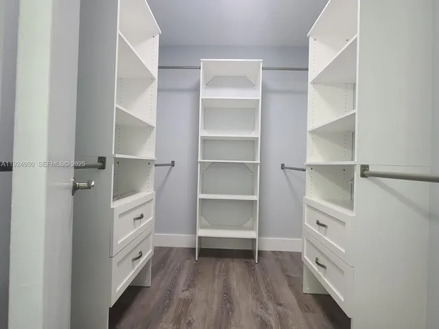 a room with walk in closet and a window