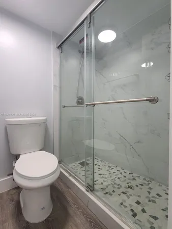 a bathroom with a toilet and a shower