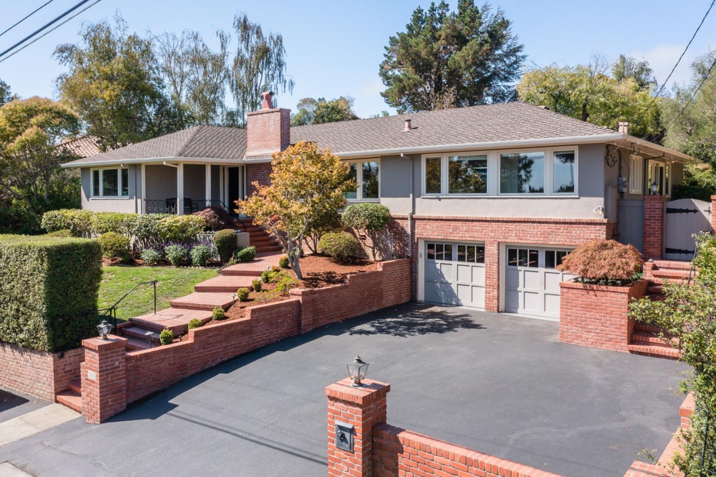 835 Longview Road Hillsborough, CA 94010 - Photo 1 of 46 a front view of a house with a yard table and chairs