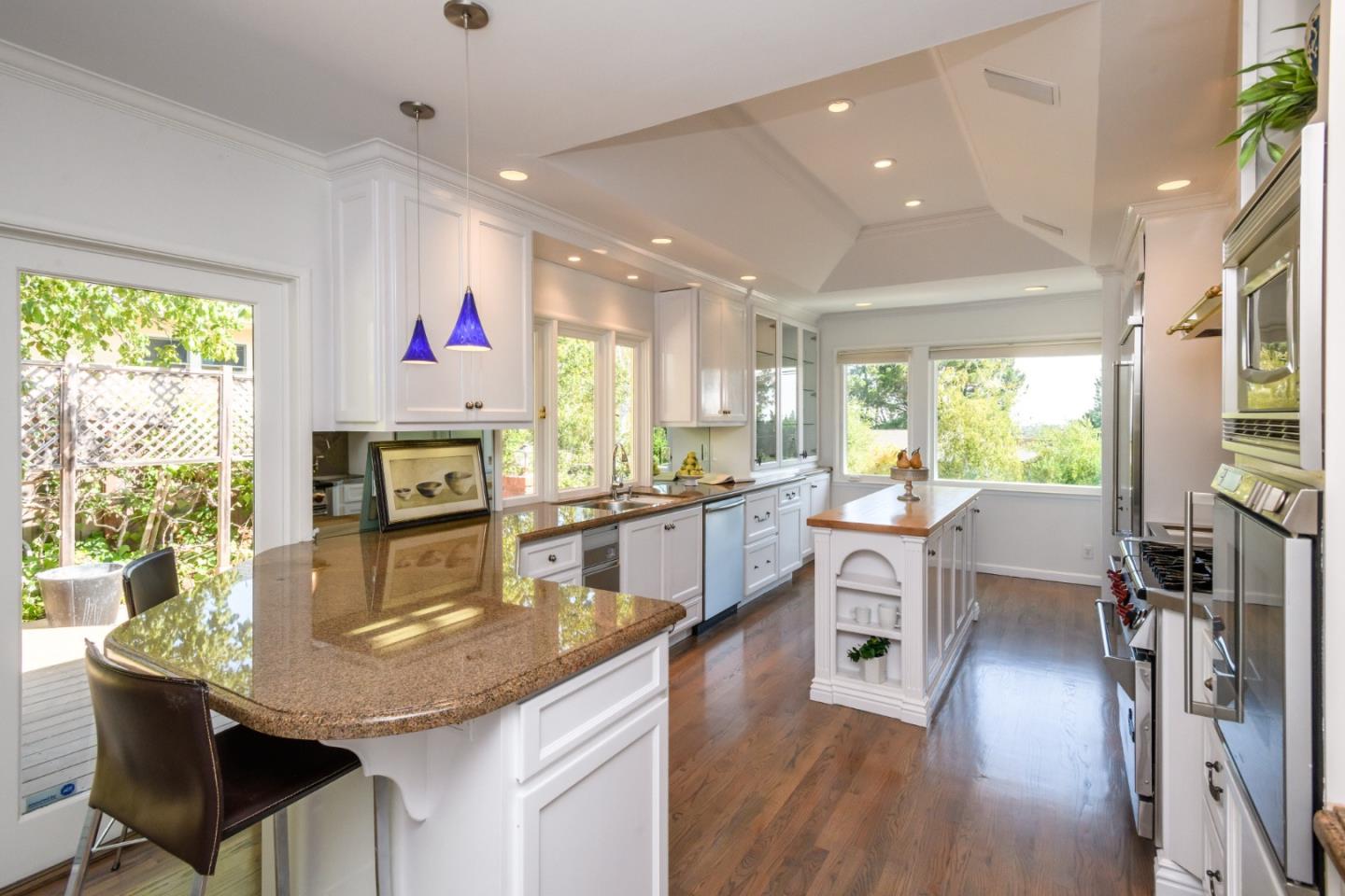 835 Longview Road Hillsborough, CA 94010 - Photo 16 of 46 a kitchen with stainless steel appliances granite countertop a stove and a wooden floors