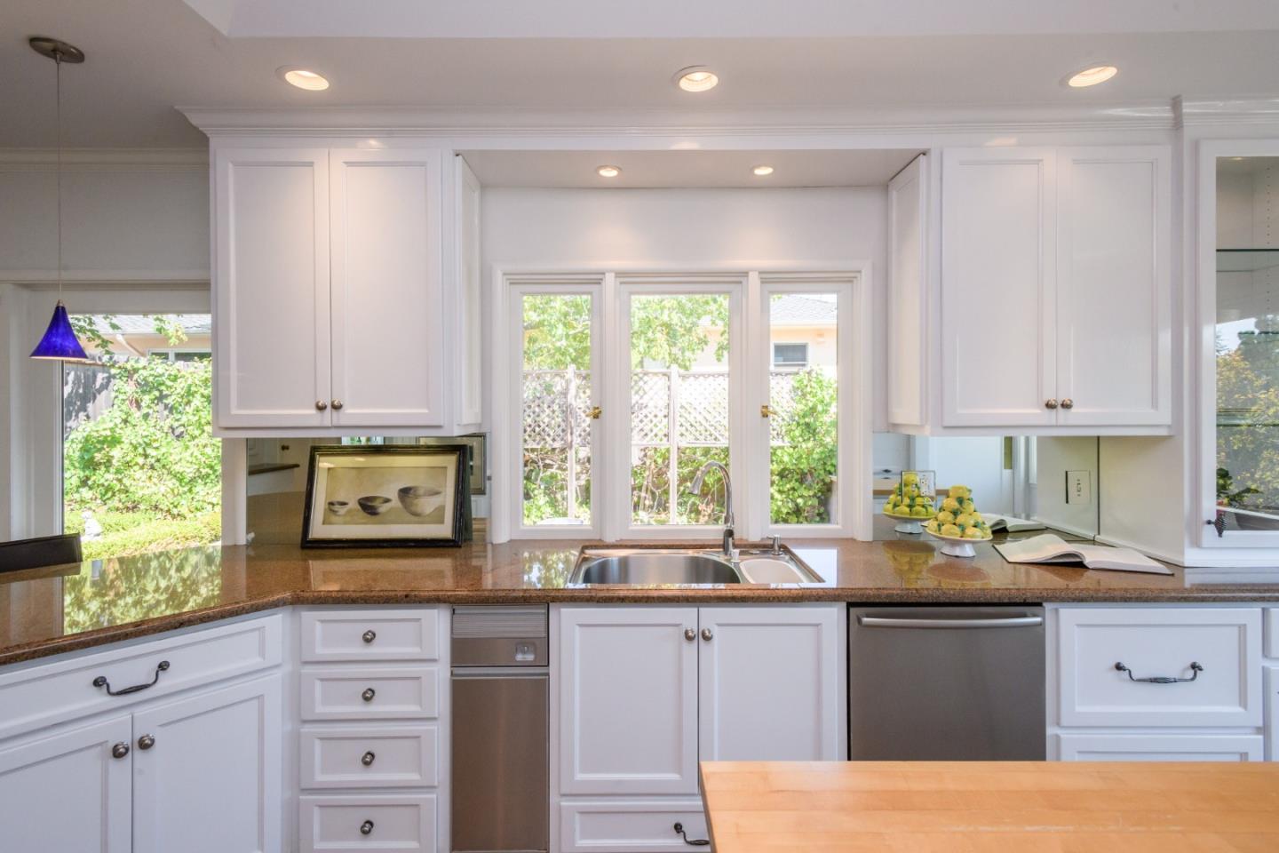 835 Longview Road Hillsborough, CA 94010 - Photo 17 of 46 a kitchen with granite countertop a stove a sink and a microwave