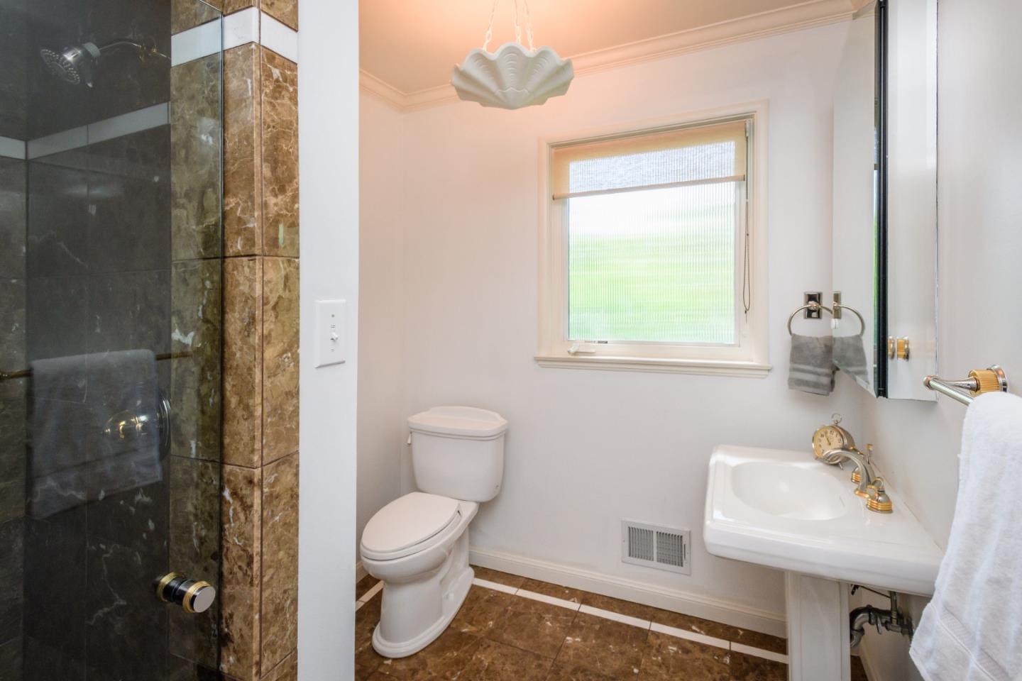835 Longview Road Hillsborough, CA 94010 - Photo 32 of 46 a bathroom with a toilet a sink and shower