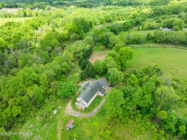 a view of a yard with table and chairs in wooden floor