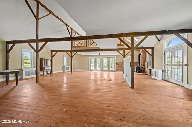 a view of an entryway with a floor to ceiling window and wooden floor