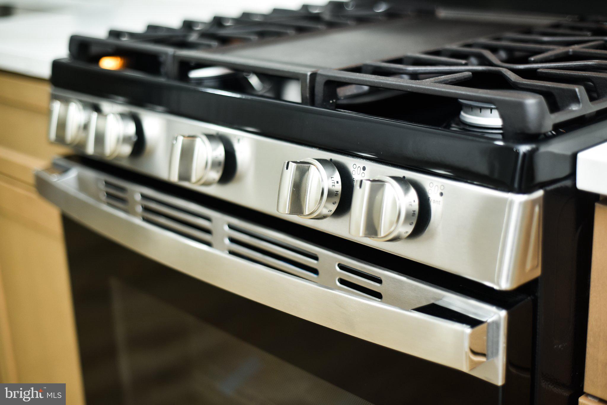 3704 Suitland Road Southeast Washington, DC 20020 - Photo 14 of 70 a close up of a stove sitting inside of a kitchen