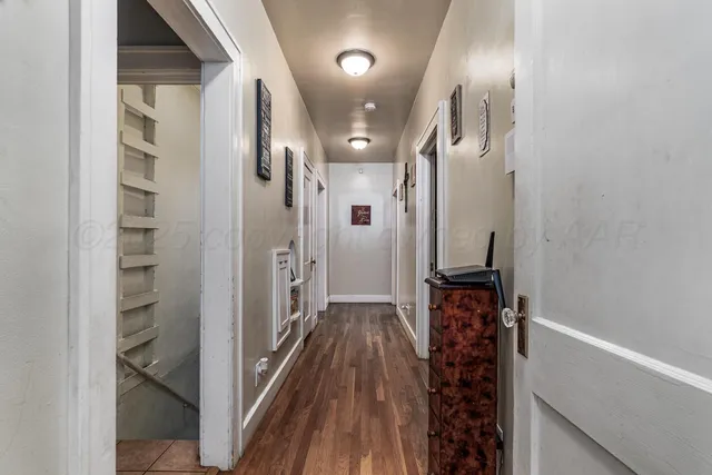 a view of hallway with wooden floor
