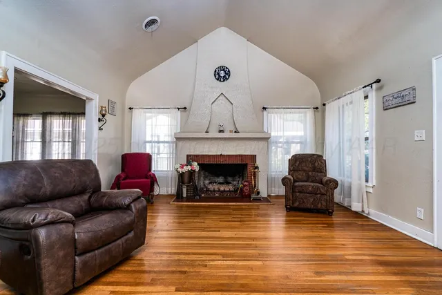 a living room with furniture and a fireplace