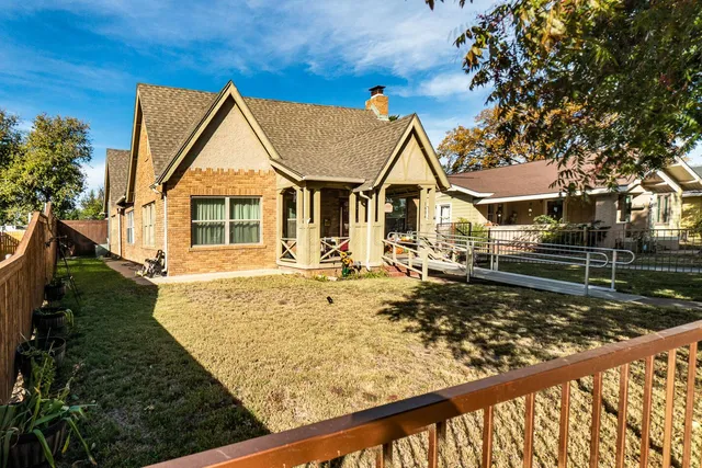a view of a house with wooden fence